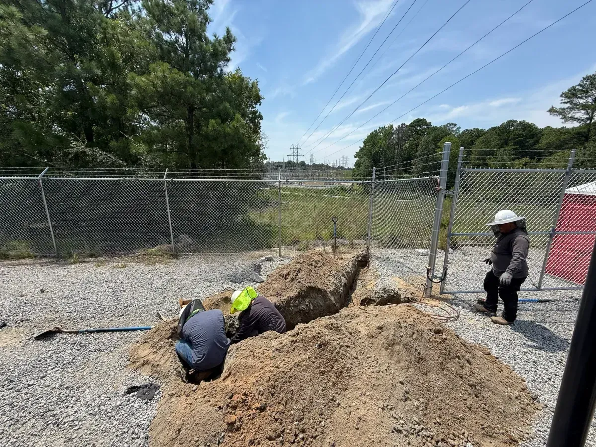Crew working by hand in a drainage trench